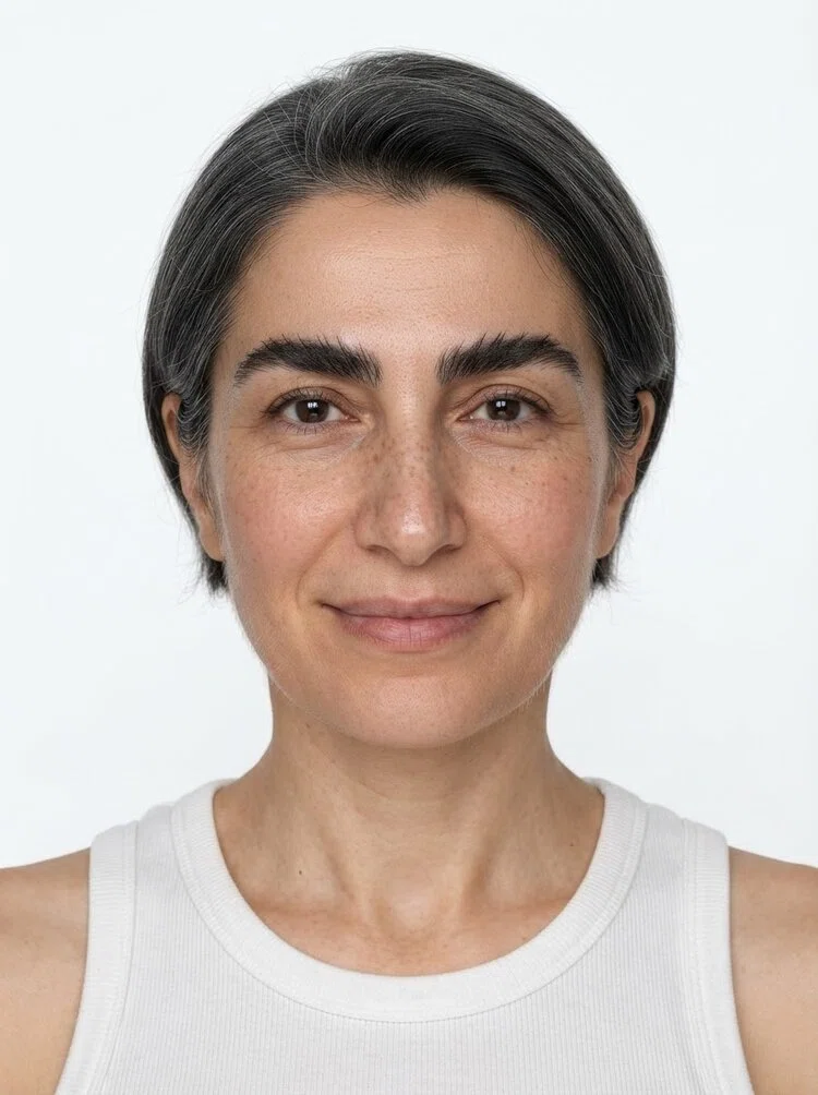 Middle-aged female fashion model with short salt-and-pepper hair, close-up.