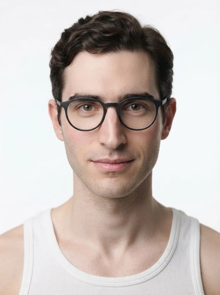 Young male fashion model with short dark brown wavy hair