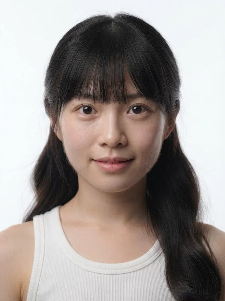 Young female fashion model with long black wavy hair with bangs