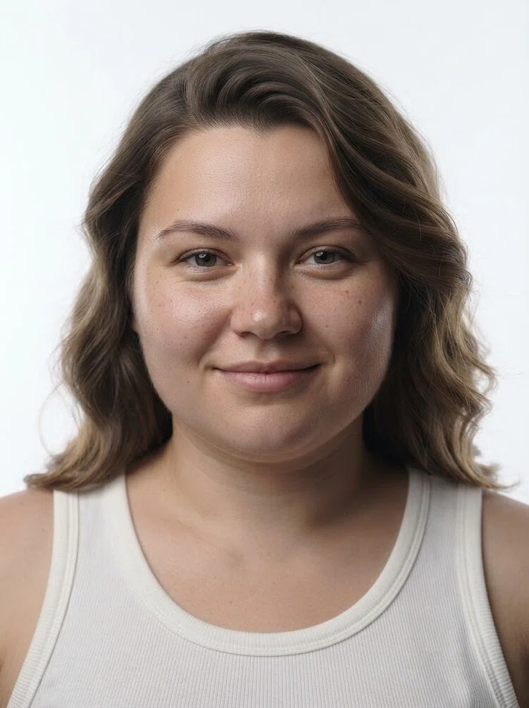 Young female fashion model with shoulder-length wavy light brown hair, close-up.