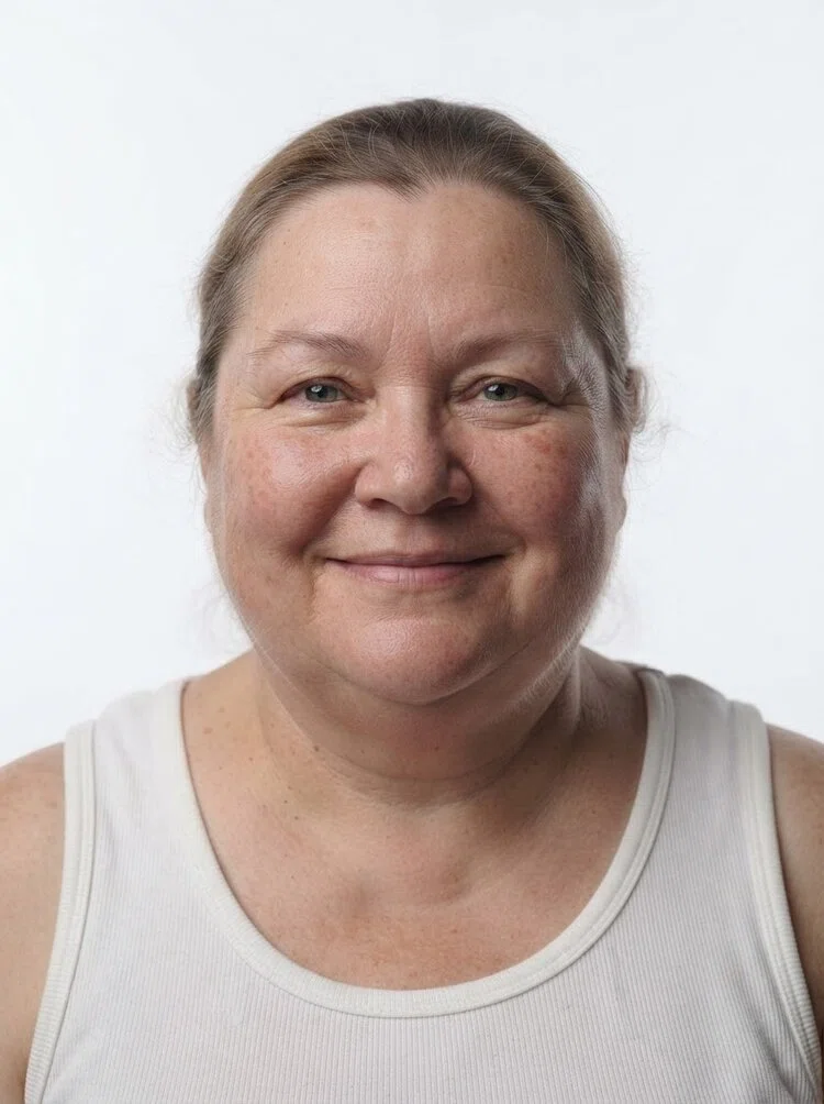 Middle-aged female fashion model with light brown hair tied back, close-up.