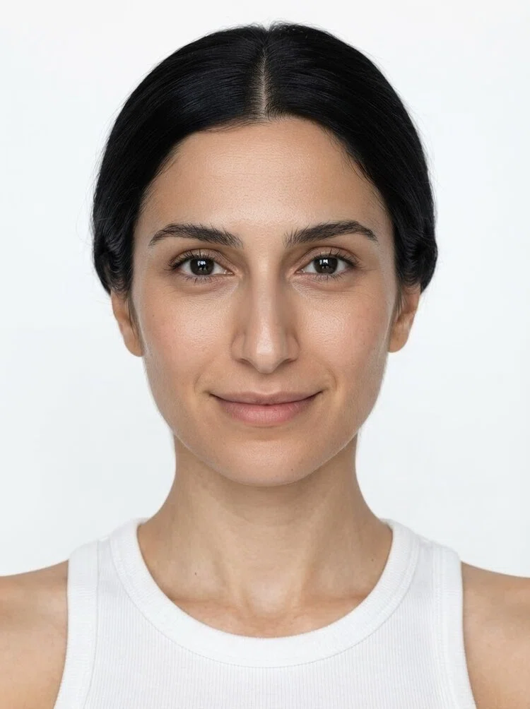 Middle-aged female fashion model with black hair in a low bun, close-up.
