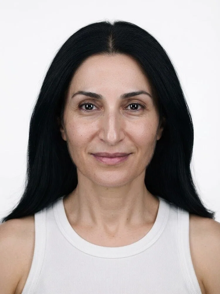 Middle-aged female fashion model with long straight black hair, close-up.