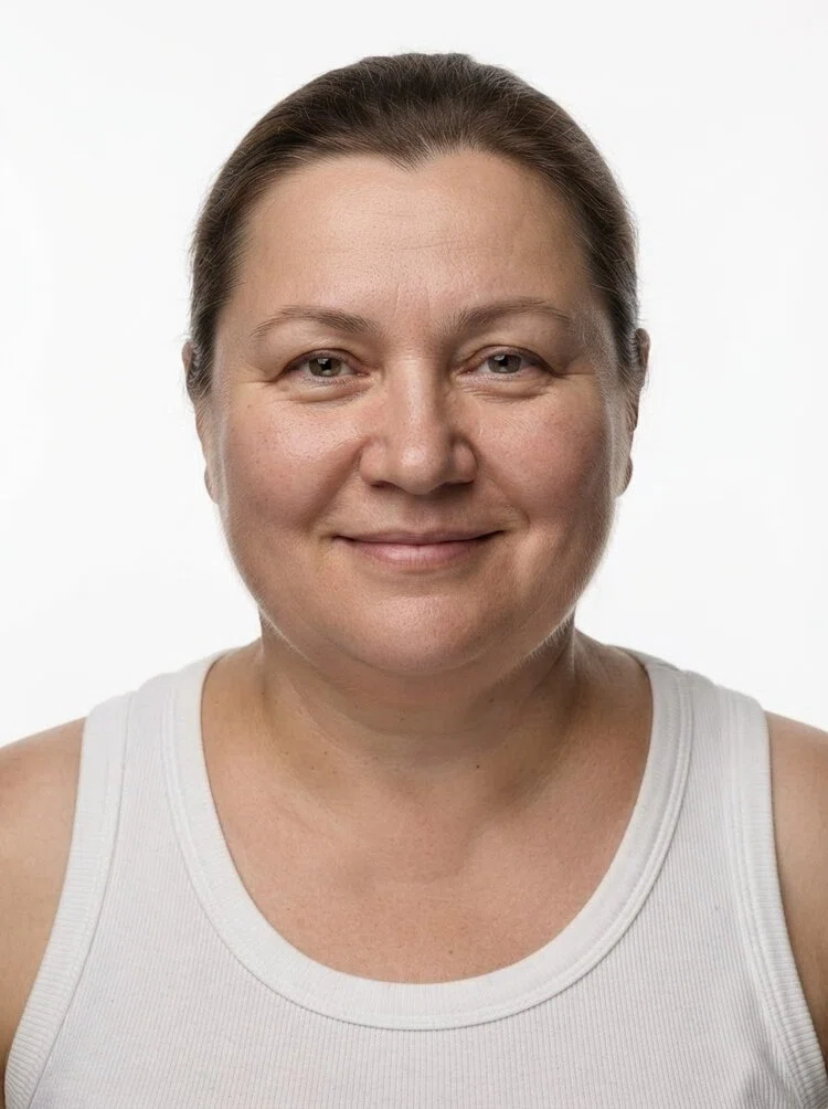 Middle-aged female fashion model with light brown hair tied back, close-up.