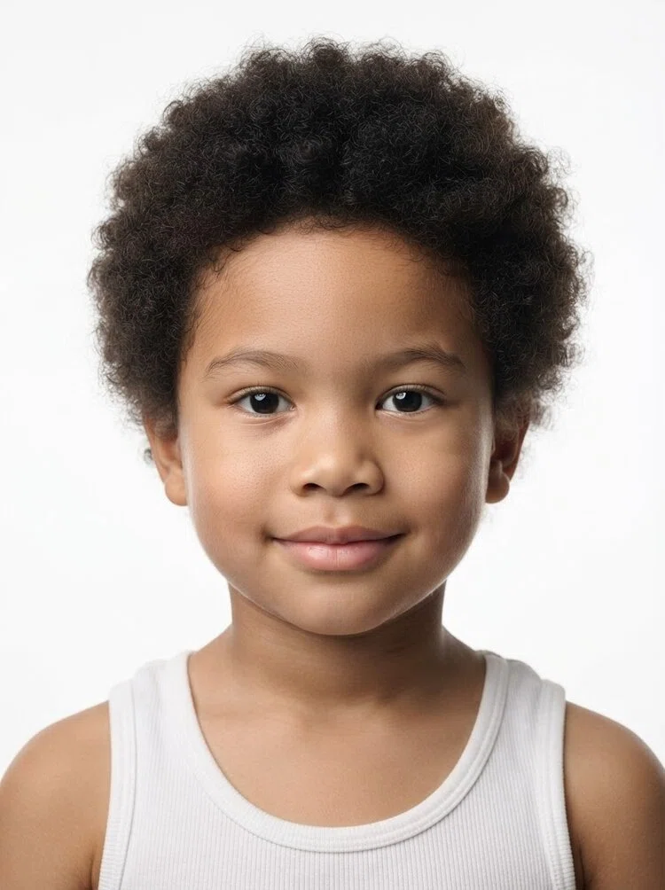 Young male fashion model with short black afro hair, close-up.
