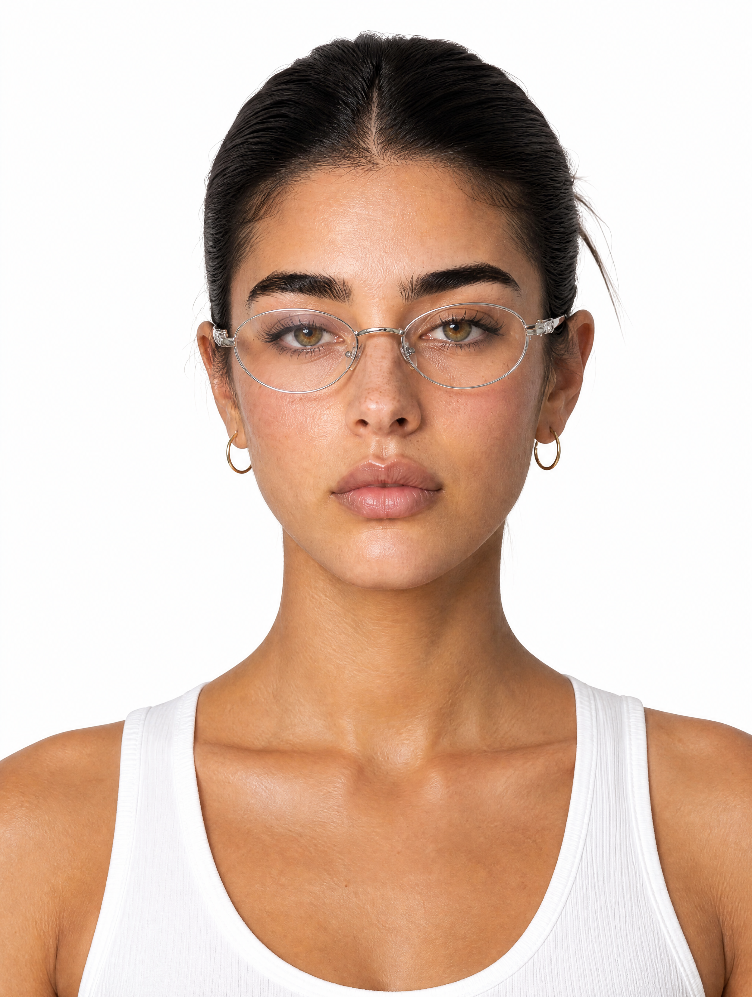 A young Latina female model wearing thin wire-frame glasses, hair tied back, gold hoop earrings, medium shot, plain white background, studio lighting, photo-realistic.