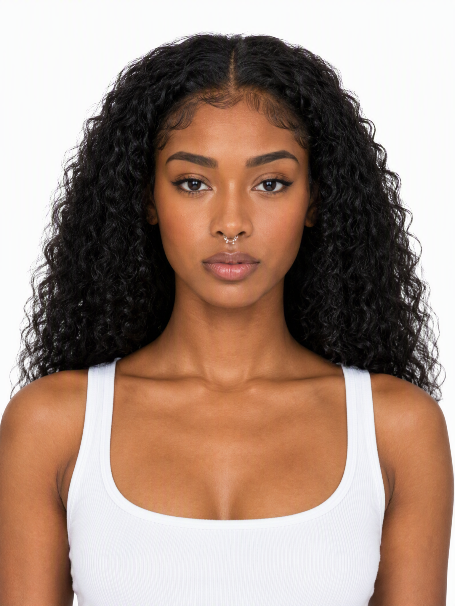 Young female fashion model with long, voluminous dark curly hair and a septum piercing.