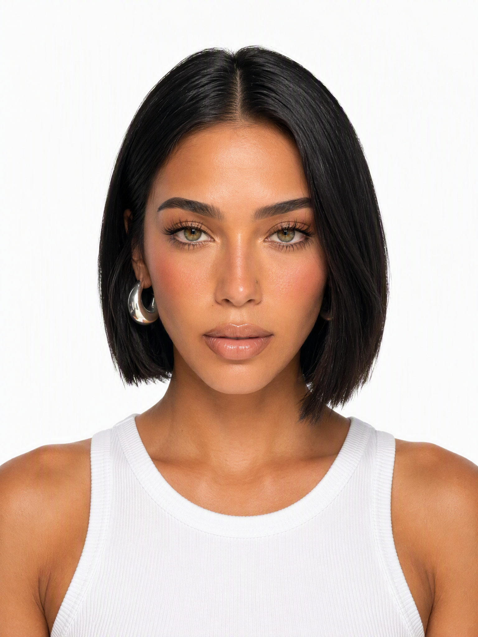 A young Latina female model with a sharp black bob hairstyle, hazel eyes, silver hoop earrings, medium shot, plain white background, studio lighting, photo-realistic.