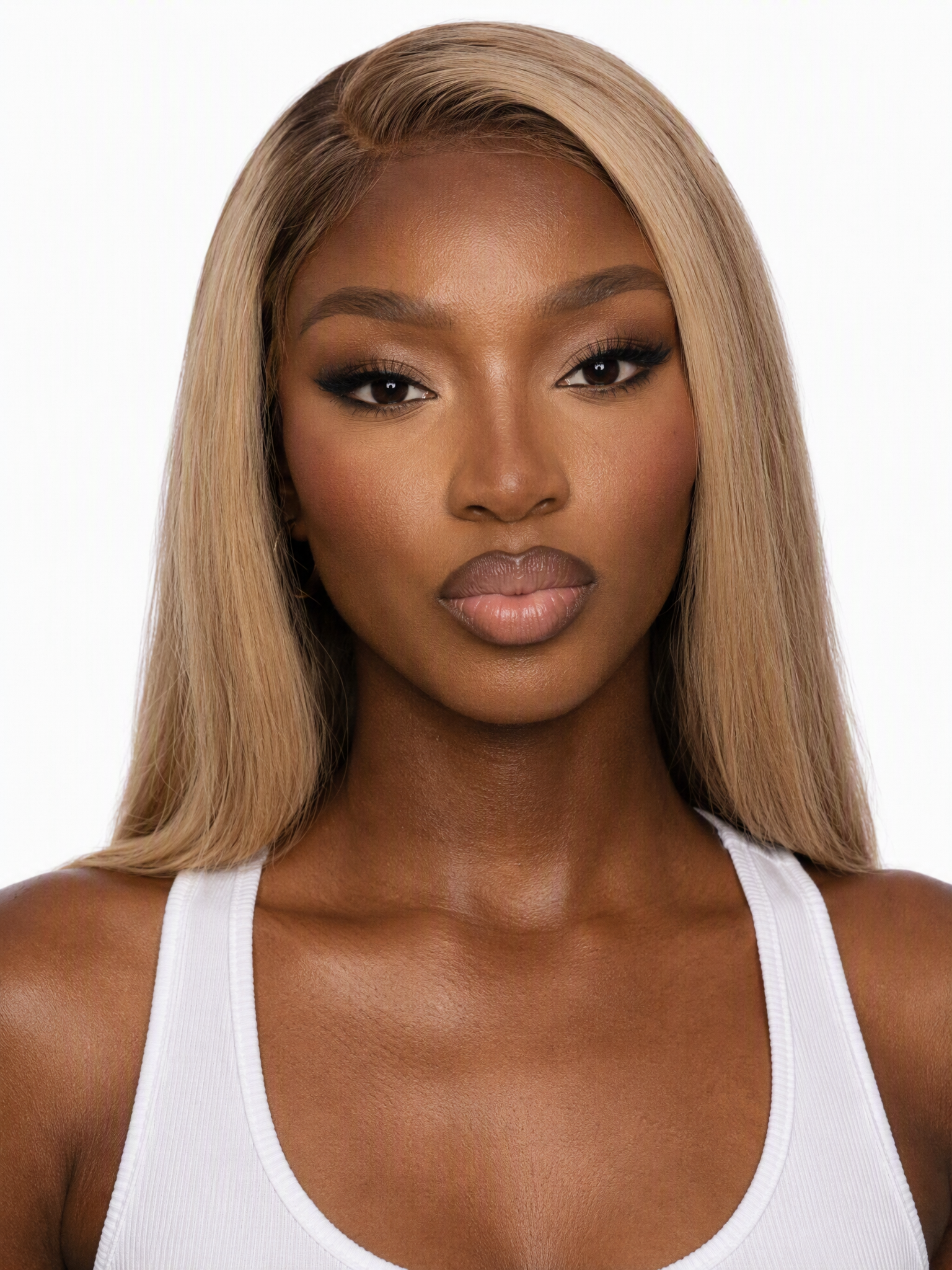 Young female fashion model with long, dark blonde hair and full glam makeup.