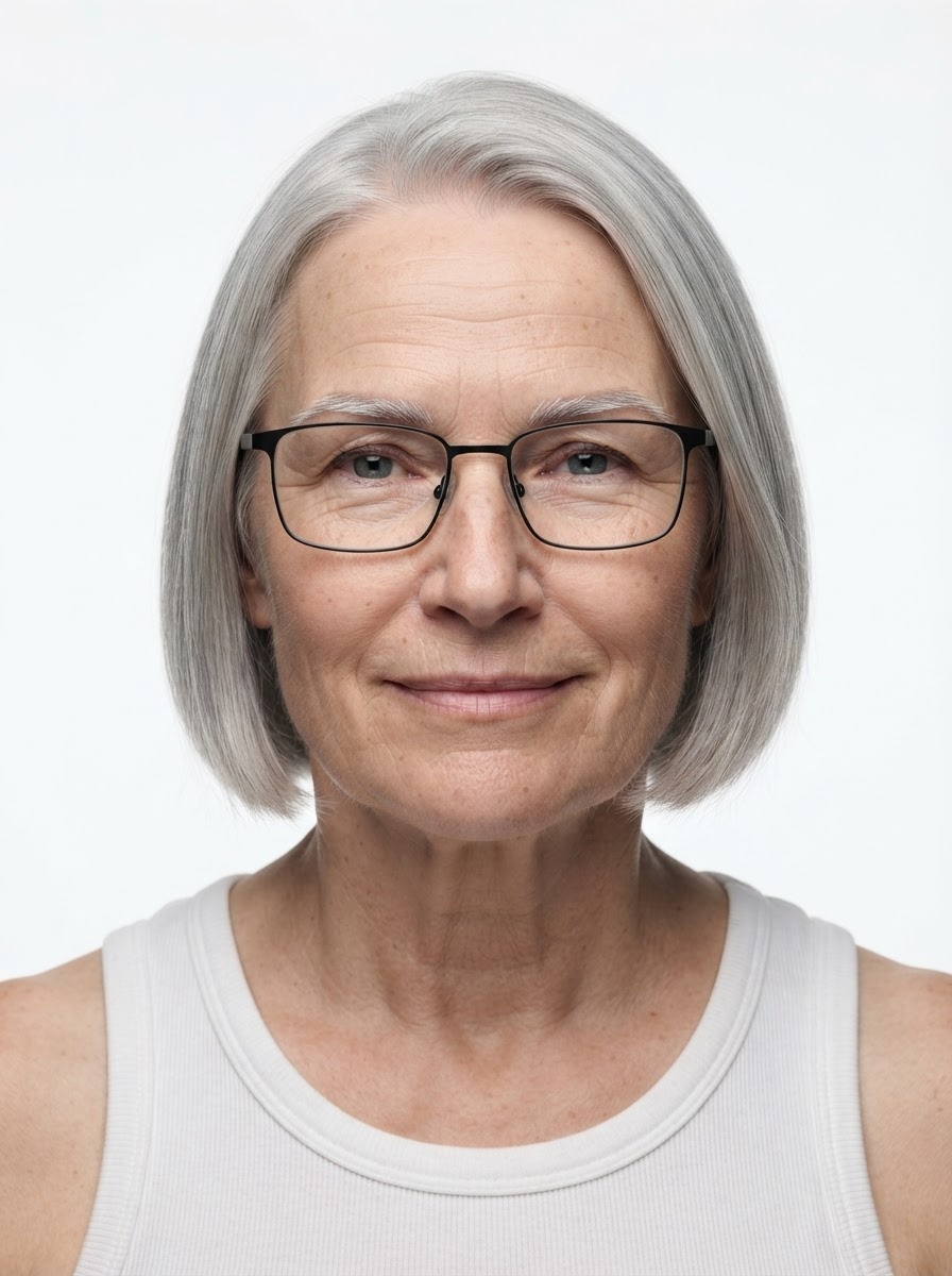 Old female fashion model with straight silver bob and glasses, close-up.